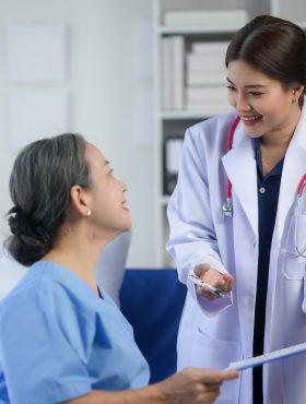 Friendly doctor consulting with a senior patient in a hospital room