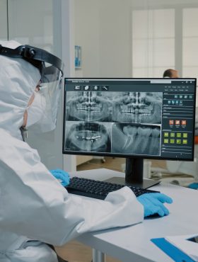 Stomatological assistant examining x ray of dentition